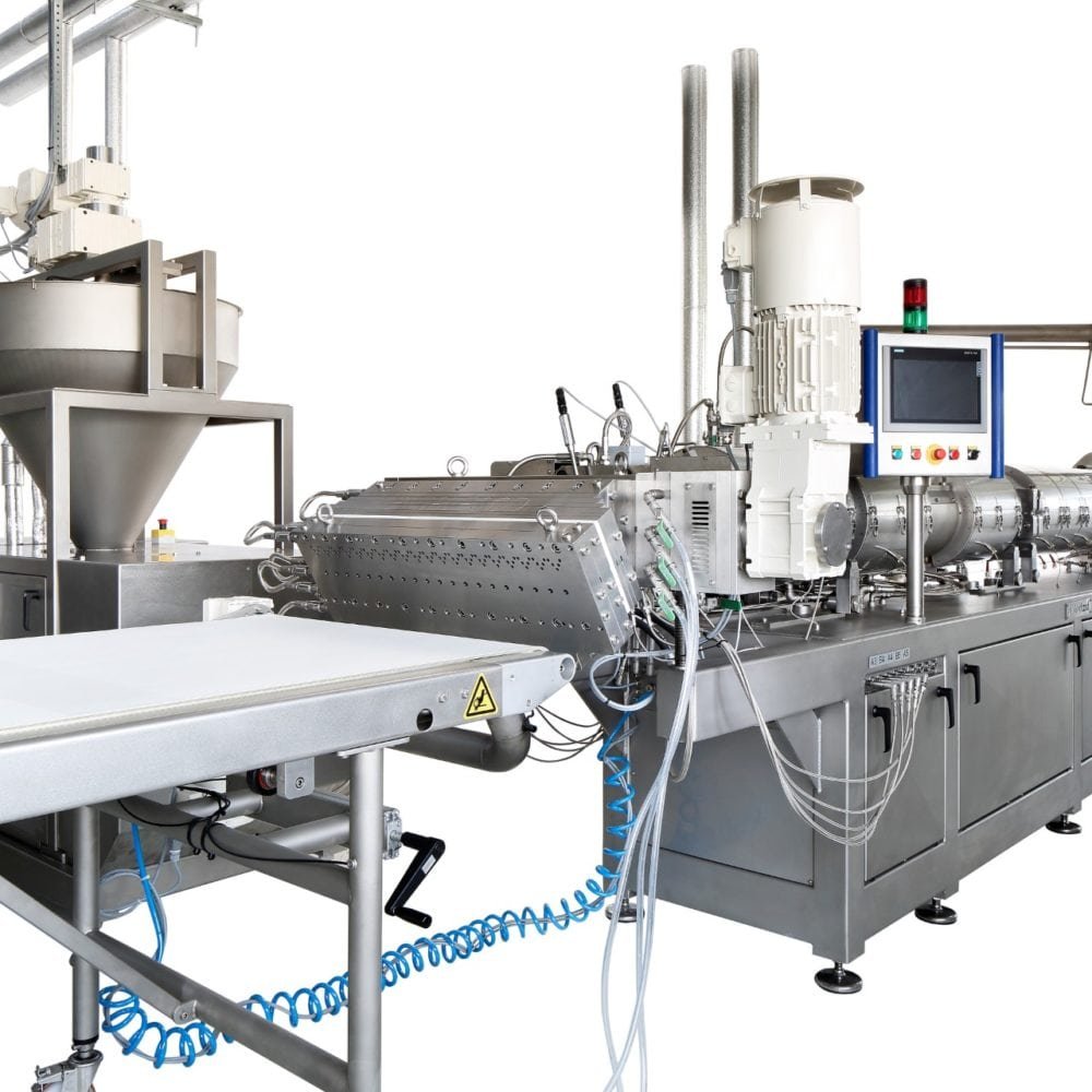 Extrufood screen changer mounted on extruder — integrated unit with control panel and start-up valve for filtering the mass before the die